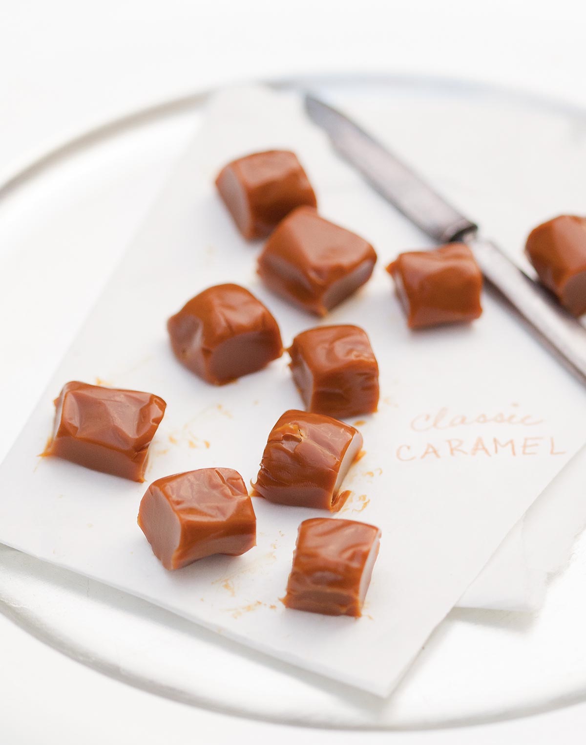 Pieces of classic caramels on a sheet of parchment.