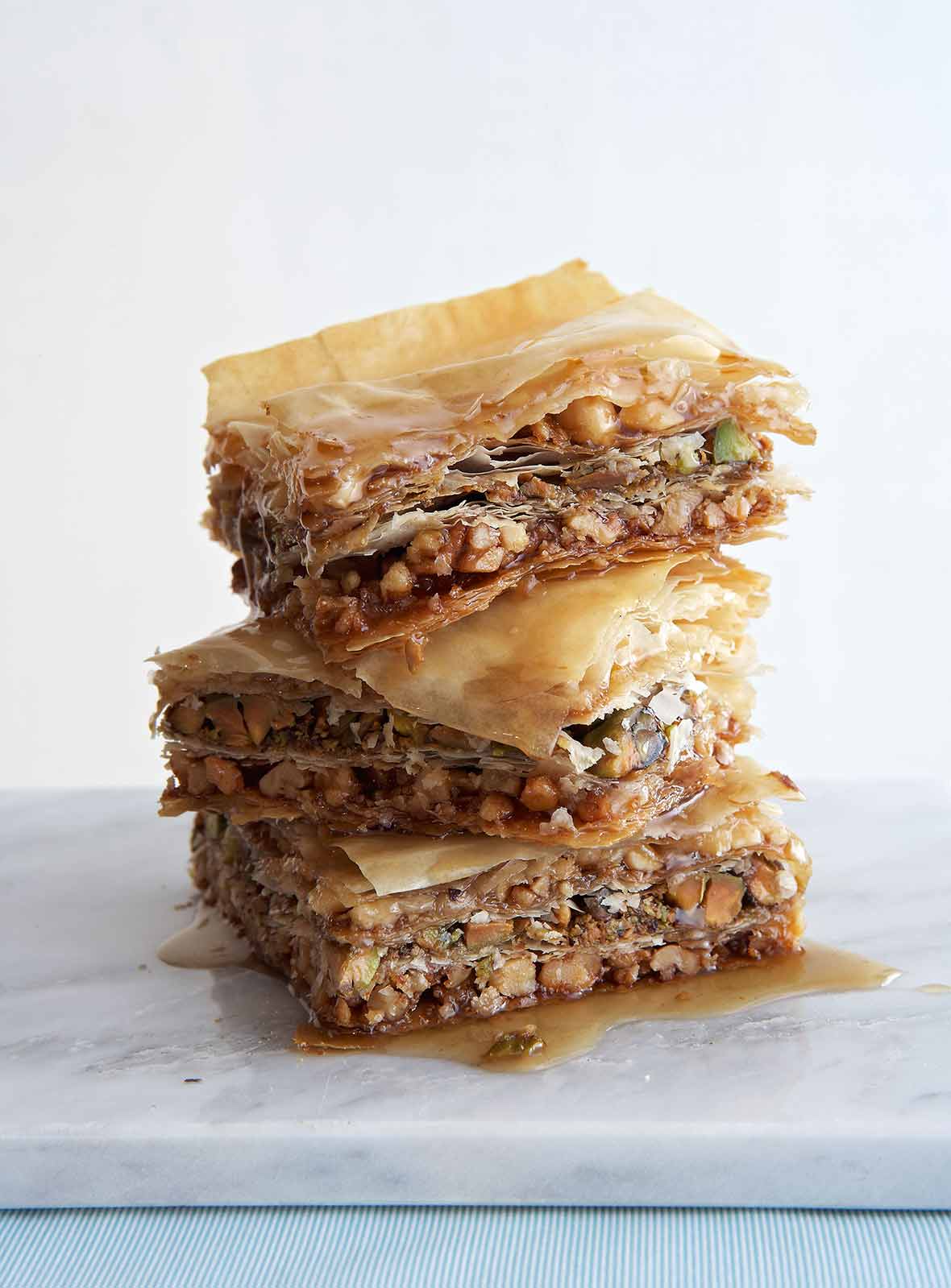 Three pieces of vegan baklava stacked on top of each other.