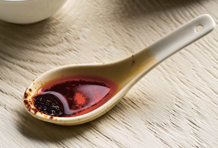 A soup spoon filled with chile oil (hong you)