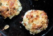 The goat cheese potato cakes in a cast iron skillet.