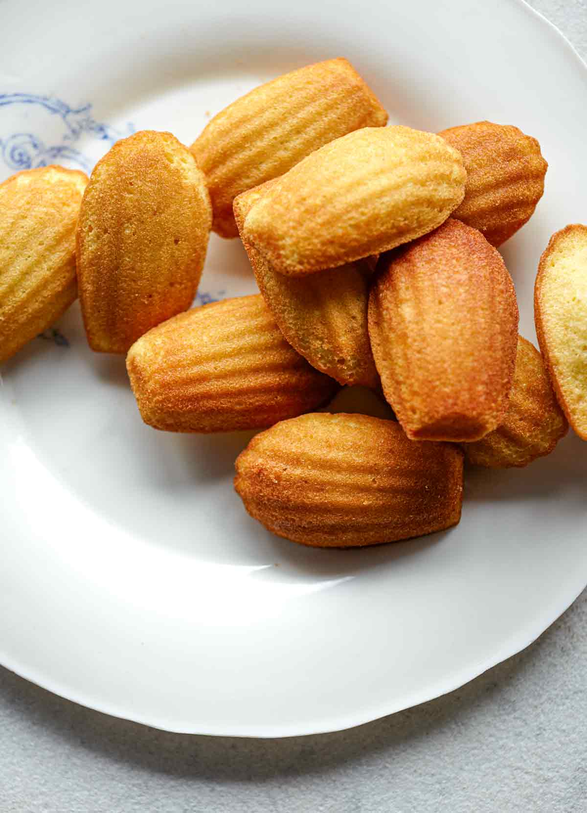 A white plate topped with classic madeleines.