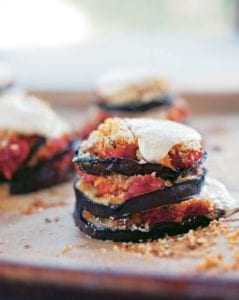 Grilled eggplant Parmesan made with stacks of eggplant slices topped with tomato sauce and mozzarella.