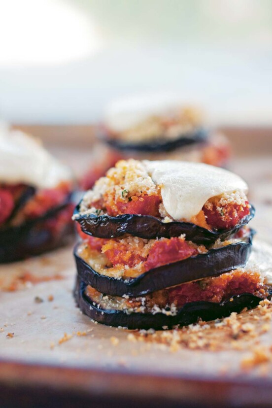 Grilled eggplant Parmesan made with stacks of eggplant slices topped with tomato sauce and mozzarella.