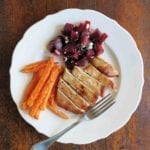 White plate with a maple pork chops, carrots, and beets with feta cheese