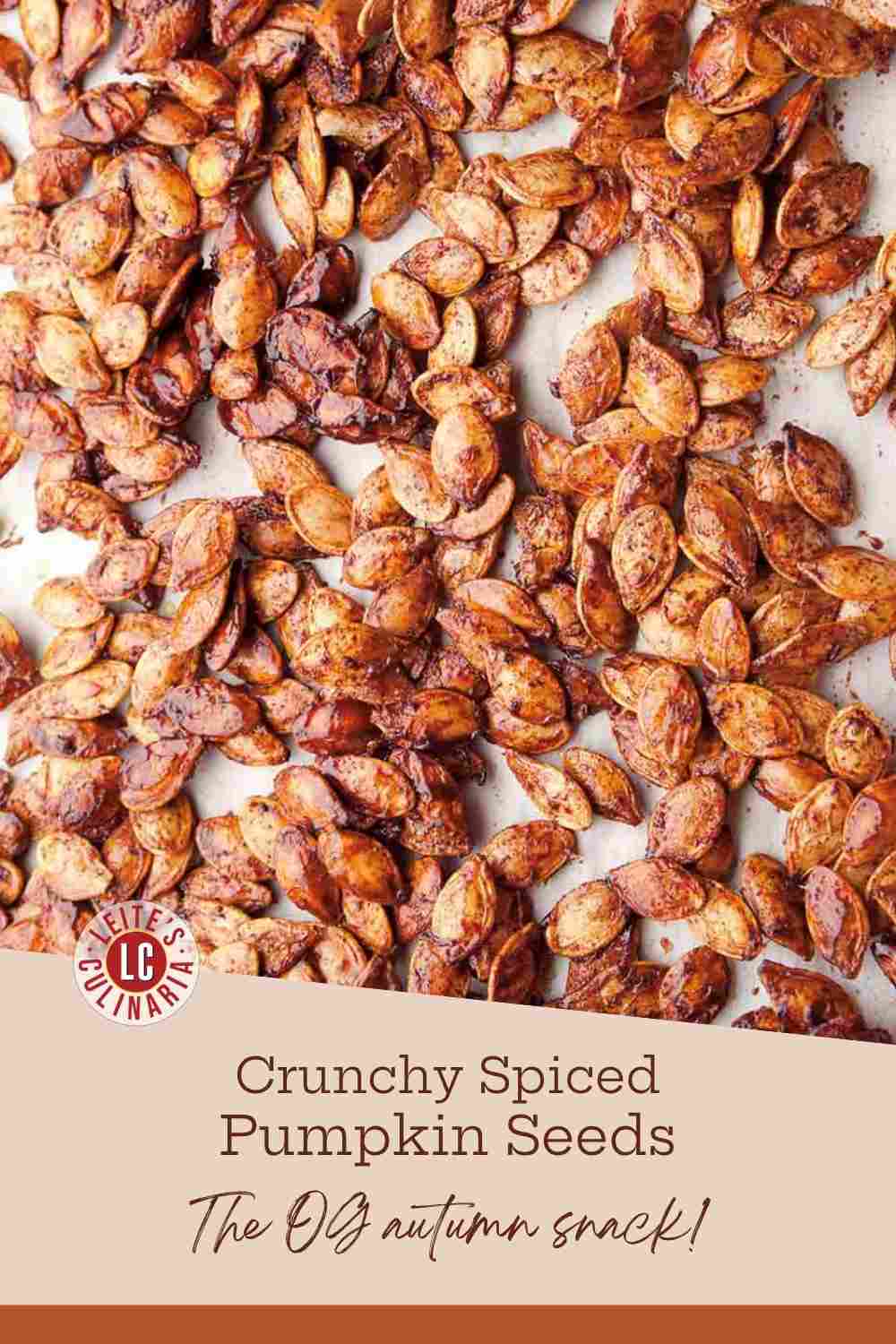 Toasted pumpkin seeds or pepitas coated in savory chili and cumin spices on a baking sheet.