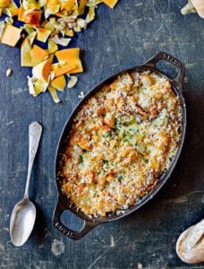 An oval gratin dish filled with butternut squash gratin