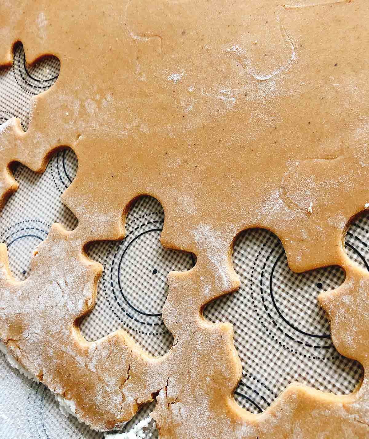 Gingerbread dough with cut outs of gingerbread men.