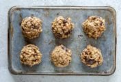 A cookie sheet with six breakfast cookies with oats, banana, figs, and peanut butter.