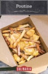 Cardboard container filled with french fries covered in melted cheese curds