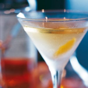 A smoky martini, garnished with a twist and served in a cold martini glass.