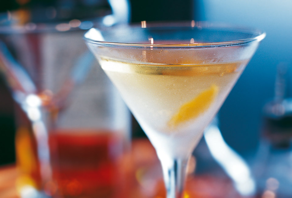 A smoky martini, garnished with a twist and served in a cold martini glass.