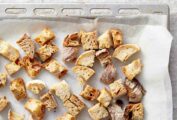 Homemade croutons in a parchment-lined baking sheet