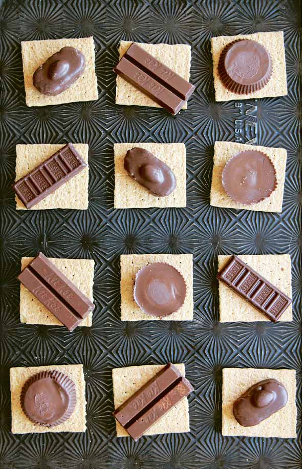 12 graham crackers topped with snack size candy bars to make candy bar s'mores.