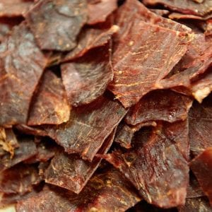 A pile of pieces of Sriracha beef jerky.
