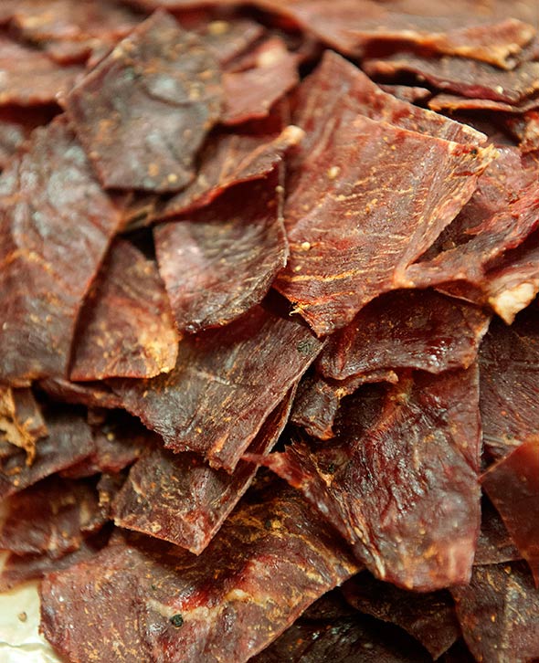 A pile of pieces of Sriracha beef jerky.