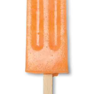 A cantaloupe popsicle with a wooden stick, on a white background.