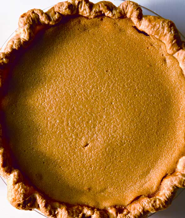 A whole cooked maple buttermilk pie in a glass pie dish.