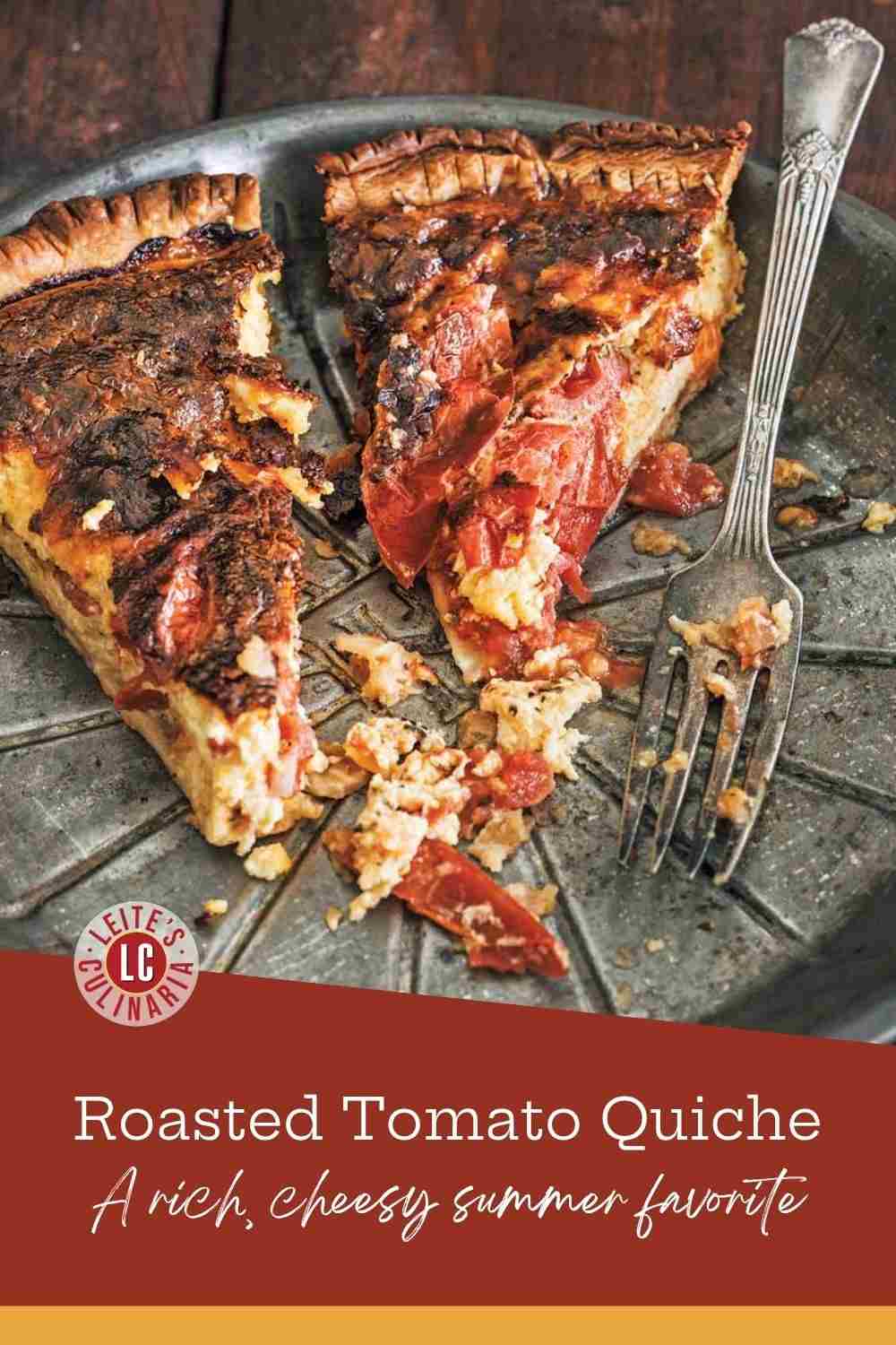Two slices of golden brown tomato quiche with melted cheese and fresh herbs on a vintage metal pie plate with a silver fork.
