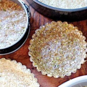 Five Vegan, Gluten-Free, and Paleo Pie Crusts each in their own tart shell or pie pan.