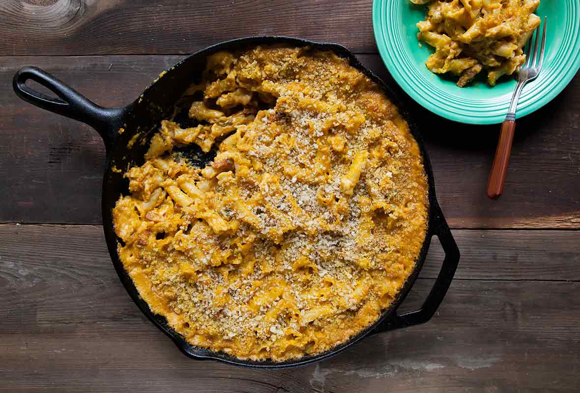 A cast-iron skillet filled with pumpkin mac and cheese