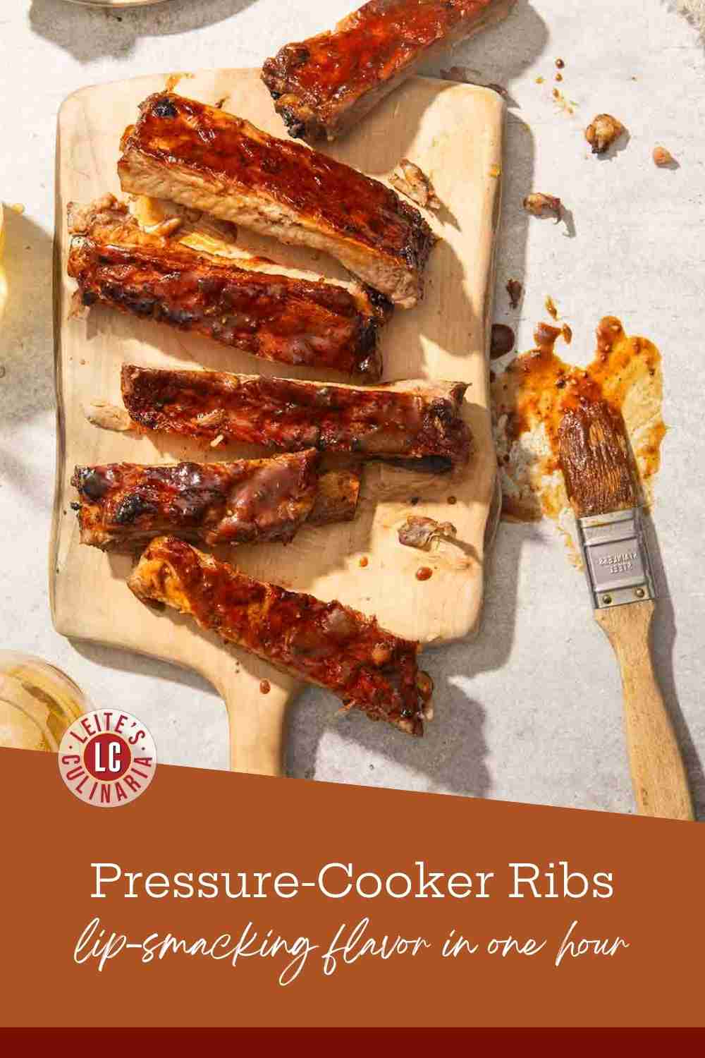 Close up of pork pressure cooker ribs on a cutting with a BBQ brush on the side.
