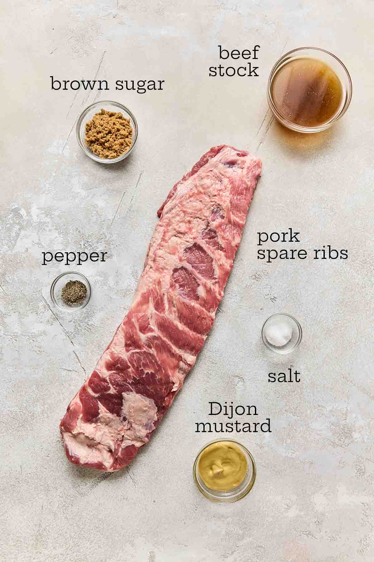 Ingredients for pressure cooker ribs--spare ribs, brown sugar, beef stock, pepper, salt, and Dijon mustard.