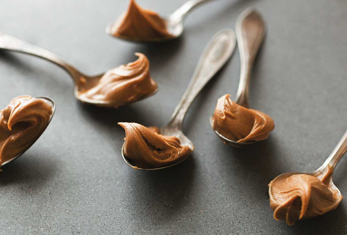 Six teaspoons - each topped with a dollop of homemade peanut butter.