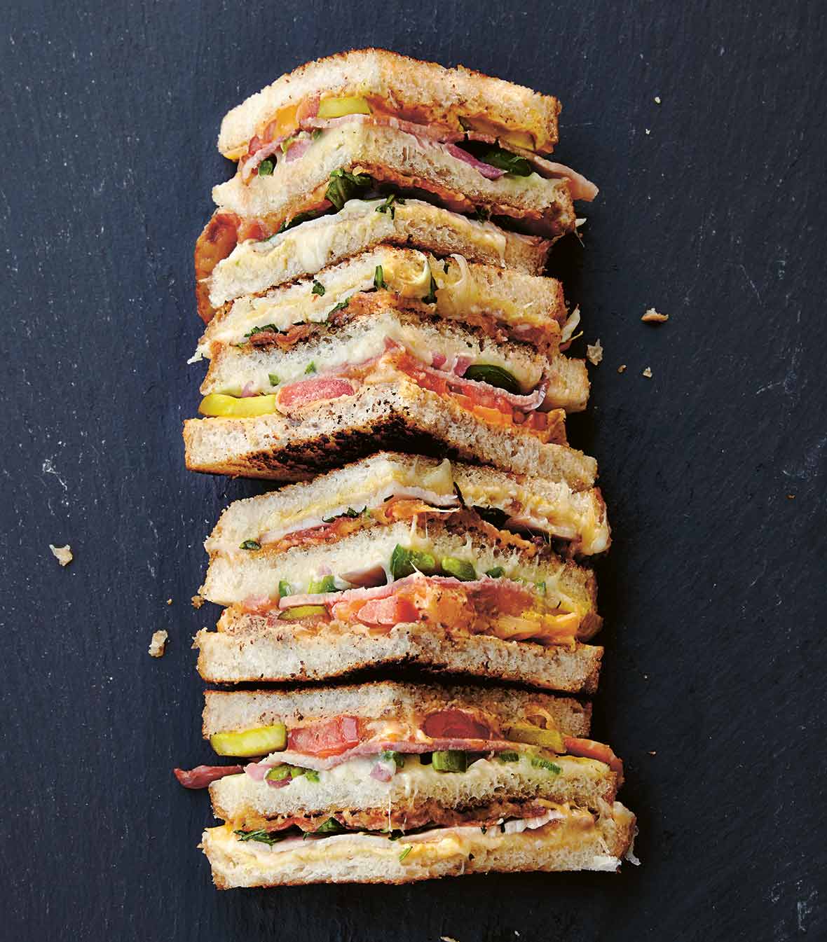 A grilled cheese with everything cut into four quarters.
