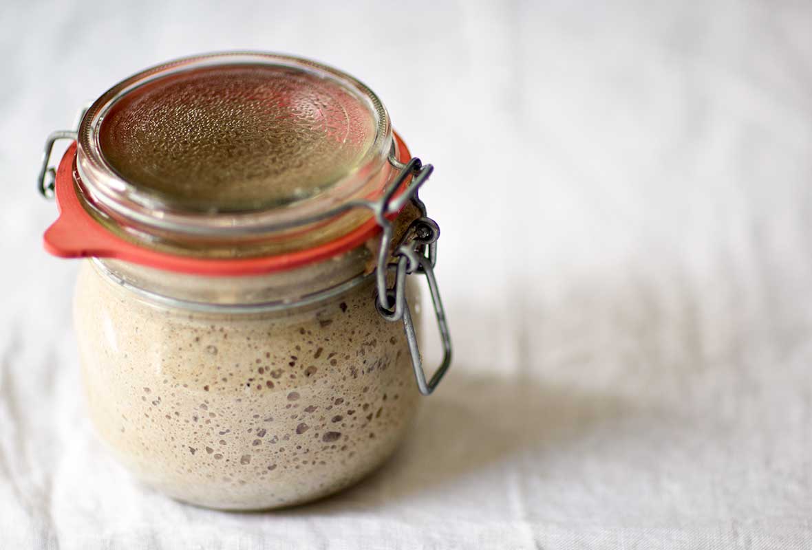 A small rubber-sealed jar of rye sourdough starter.