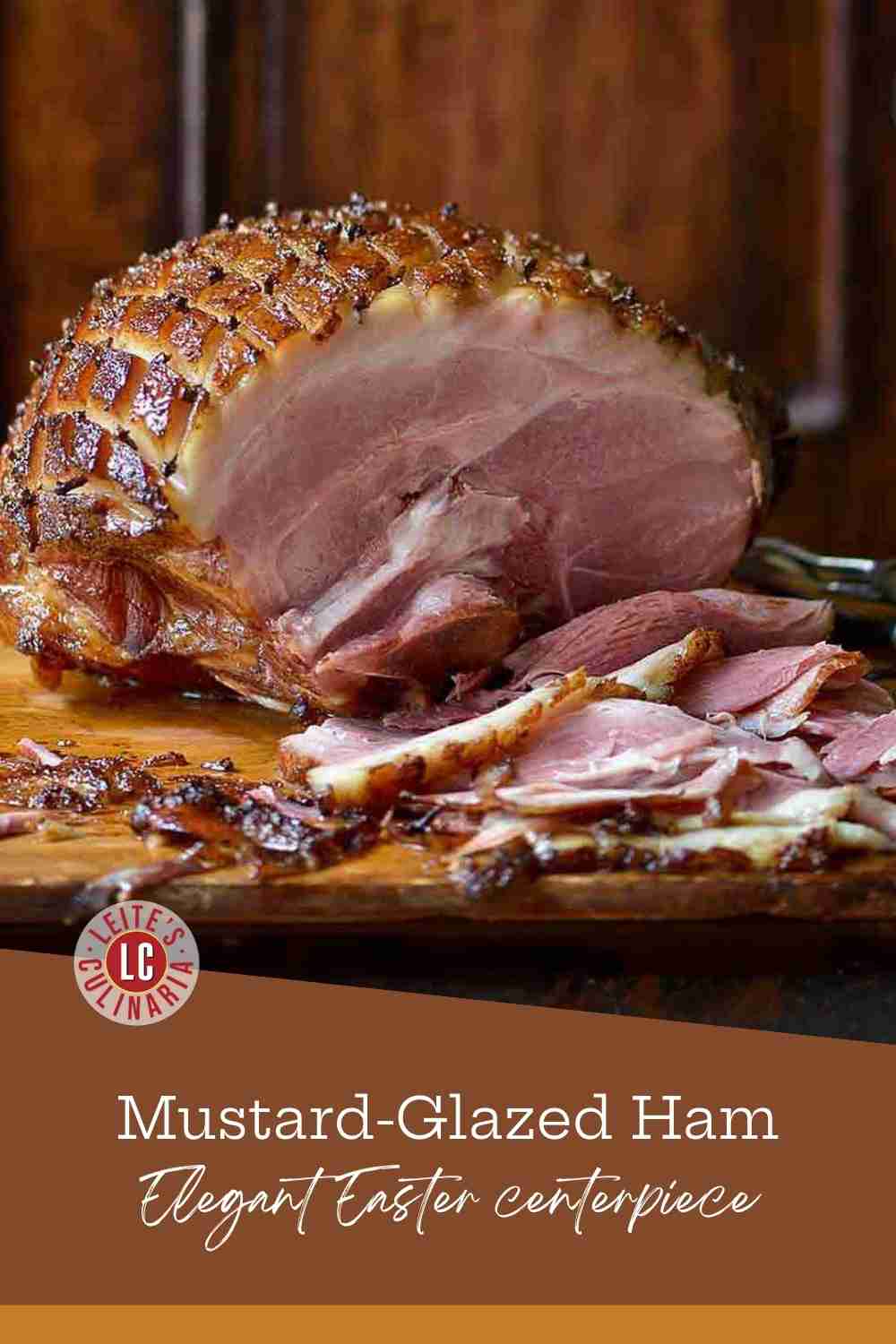 Close up of a sliced mustard-glazed ham with a scored, caramelized brown crust on a wooden board.