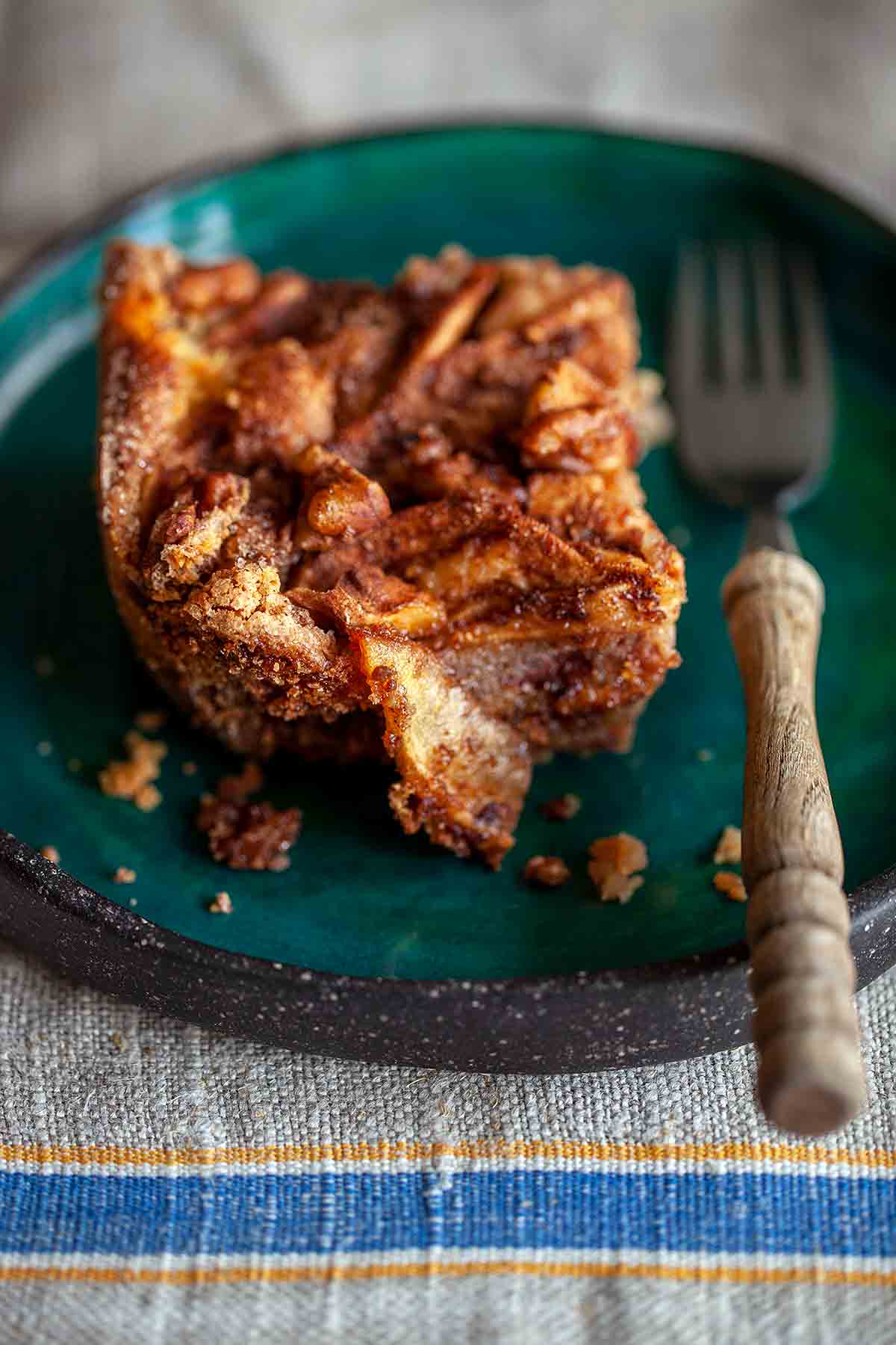 A square of Passover apple cake on a green plate.