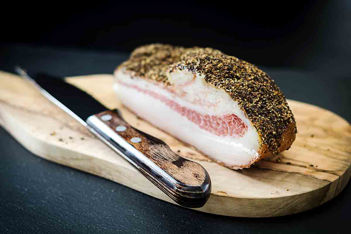 A slab of guanciale on a cutting board