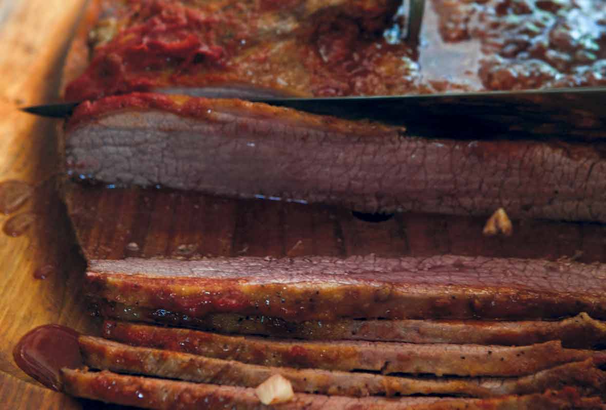 Slices of Nach Waxman's beef brisket on a cutting board