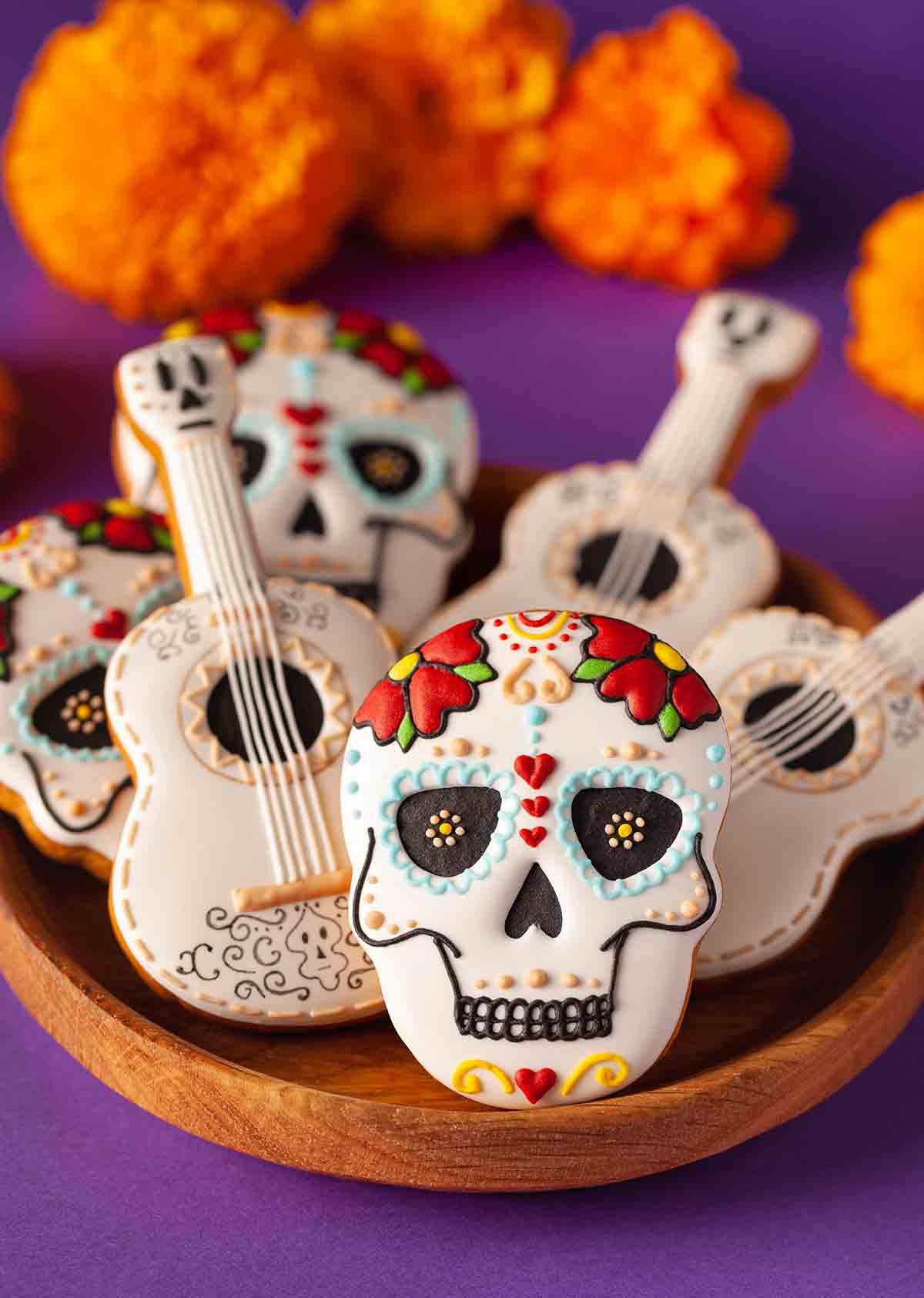 A platter of decorated Day of the Dead cookies and decorated guitar cookies.