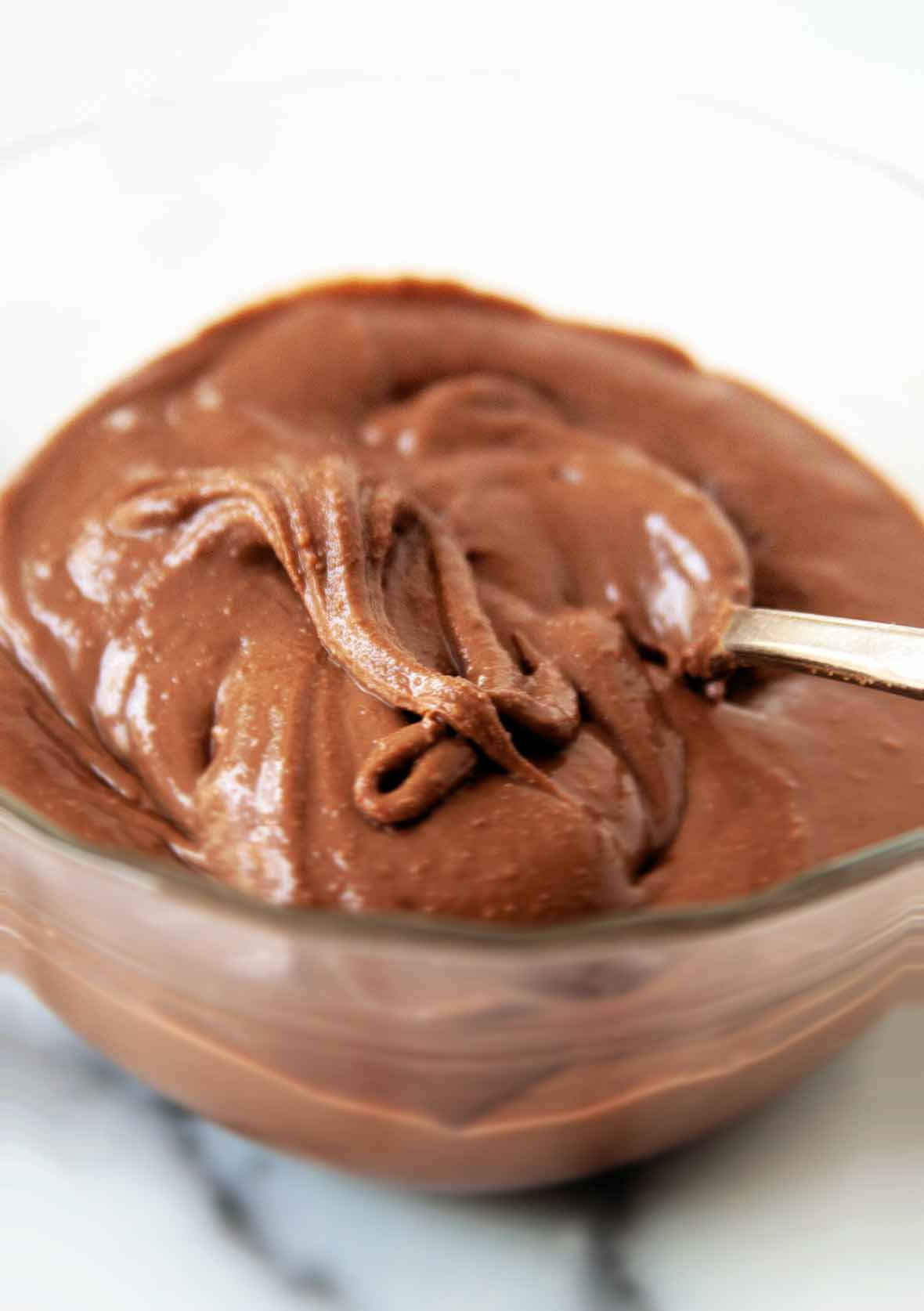 A bowl of homemade nutella with a spoon resting in it