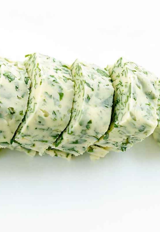 a roll of butter flecked with minced parsley