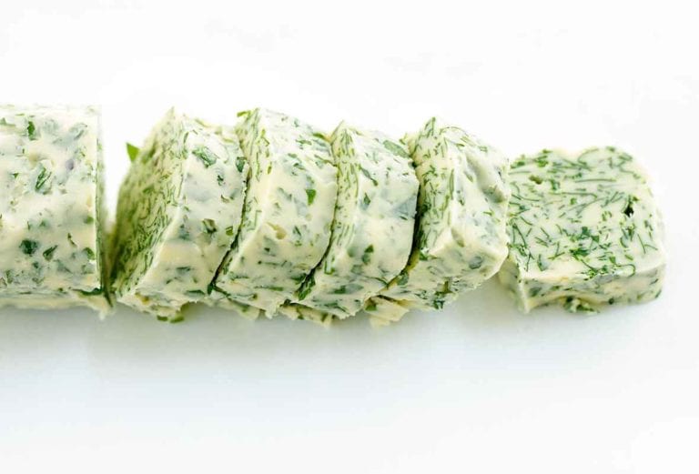 a roll of butter flecked with minced parsley