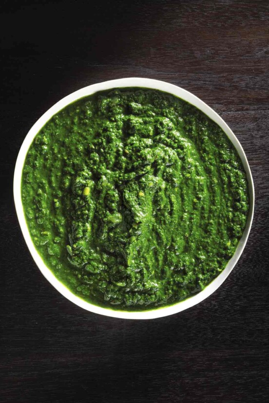 Bowl of Indian creamed spinach on black wood