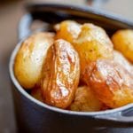 Cast iron pot with braised new potatoes inside