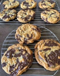 Seven of David Leite's chocolate chip cookies cooling on wire racks