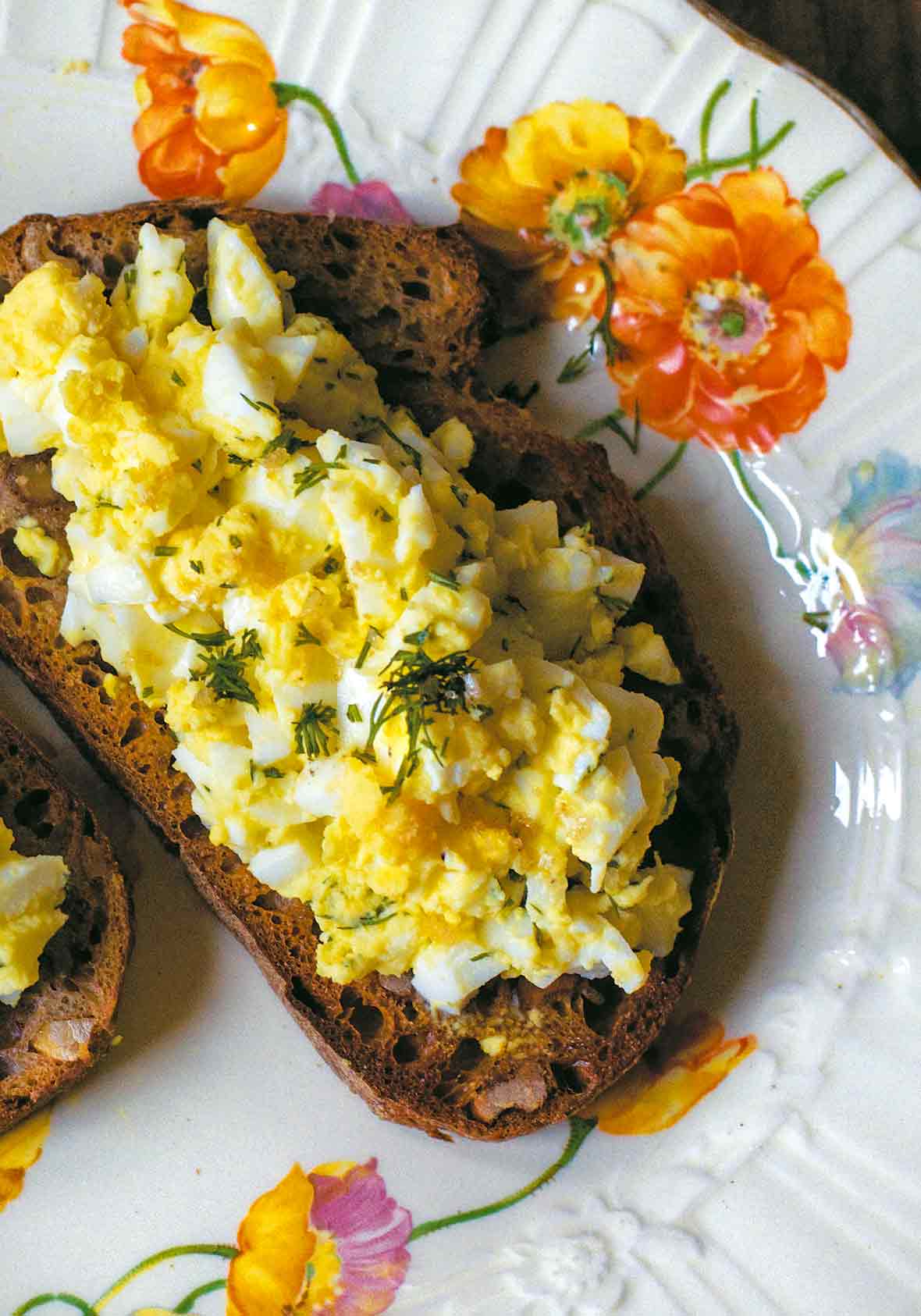 An open face egg salad sandwich on toasted whole wheat