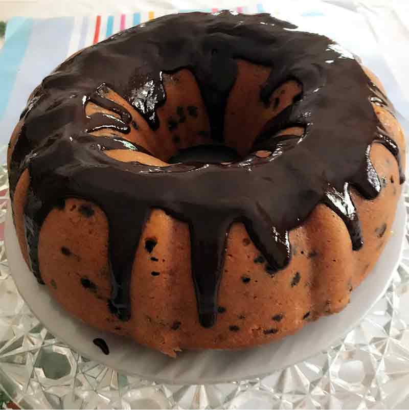 Ina Garten's orange chocolate cake, which is an  orange Bundt cake, speckled with chocolate chips, and topped with a ganache drizzle