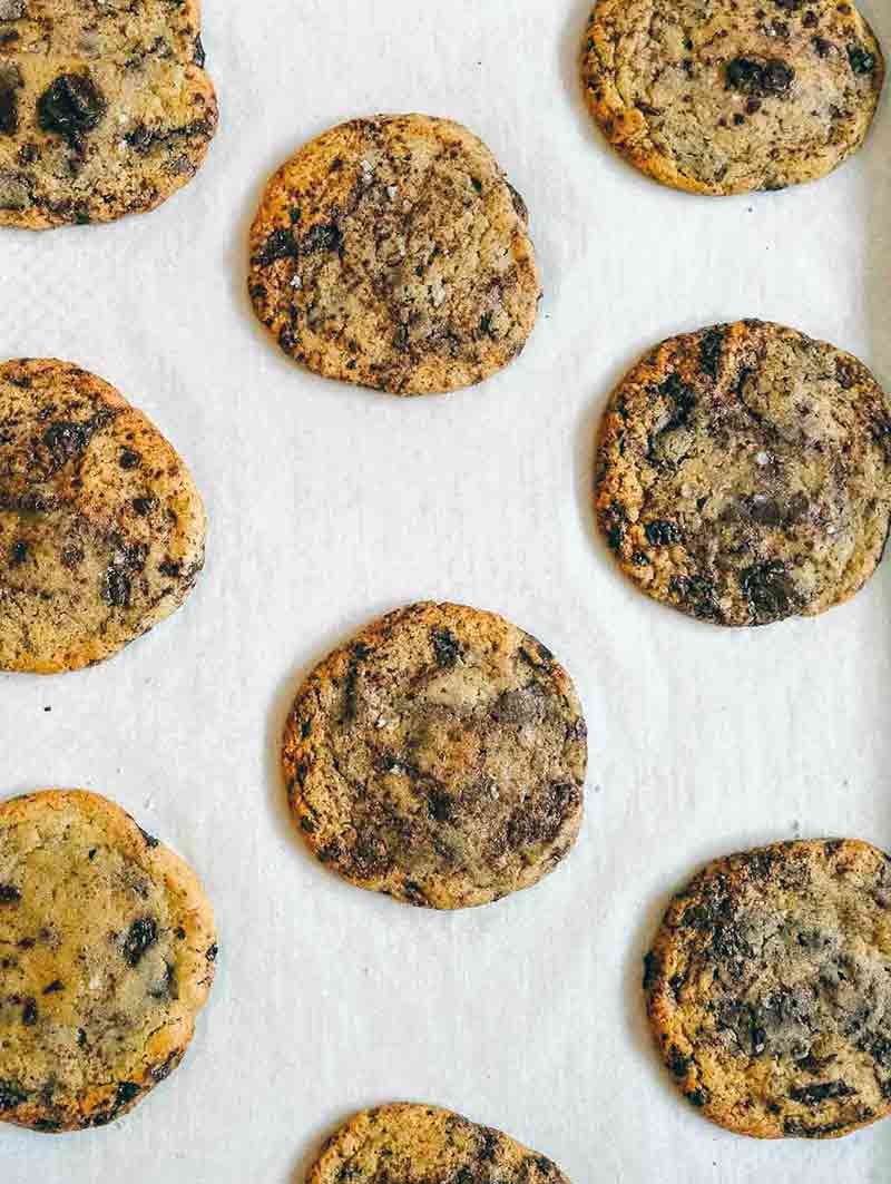 Parchment-lined baking sheet with 9 thousand layer chocolate chip cookies