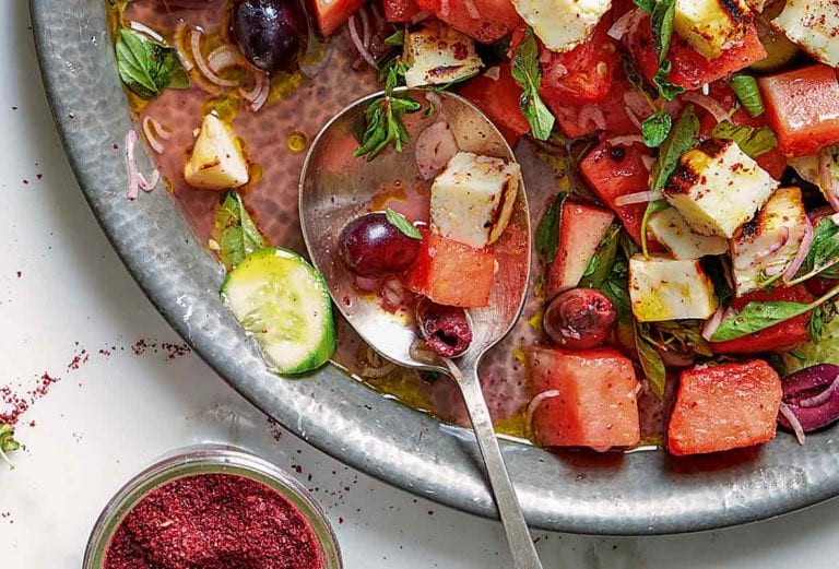 Bowl of watermelon, halloumi and za’atar salad, which also has cucumbers, olives, and grapes