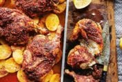 A pan of harissa roasted chicken sitting on top of sliced roasted potatoes, nearby a cutting board and knife.