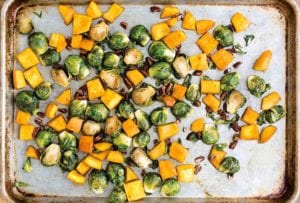 Sheet pan with chunks of roasted pumpkin and Brussels sprouts