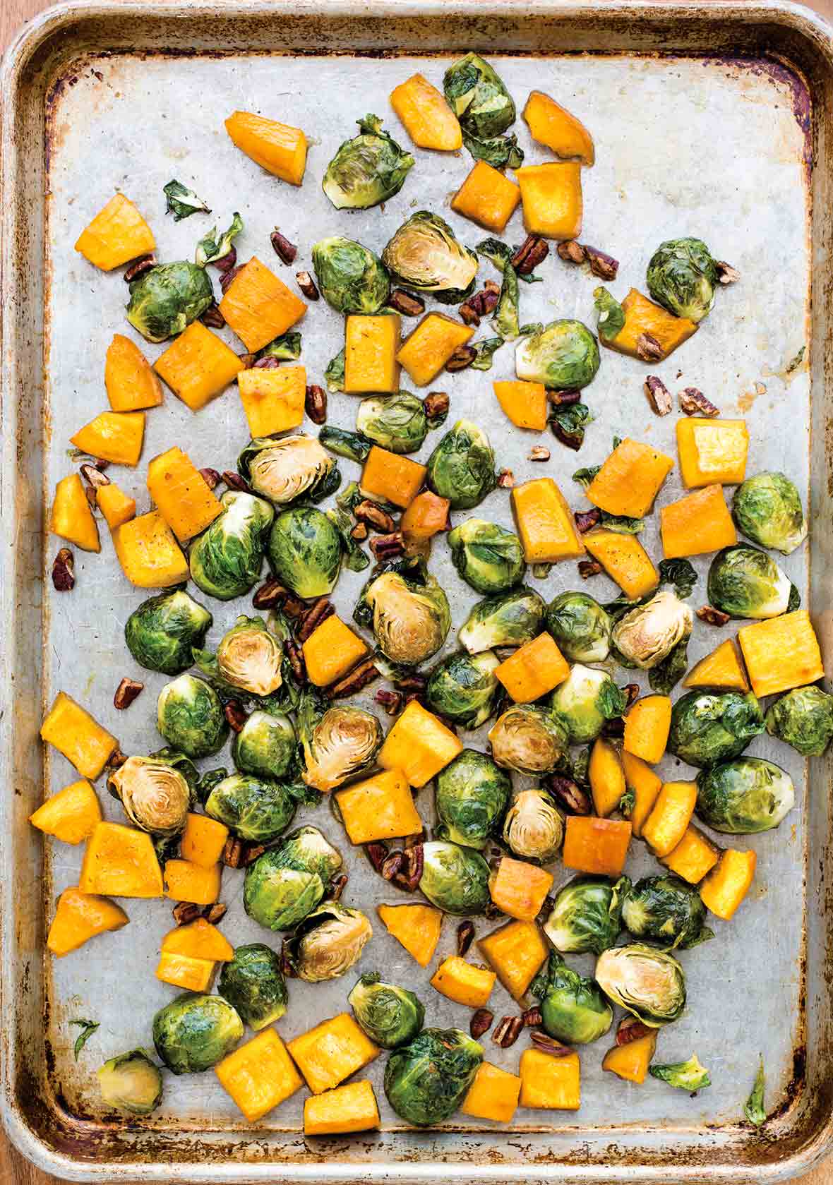 Sheet pan with chunks of roasted pumpkin and Brussels sprouts