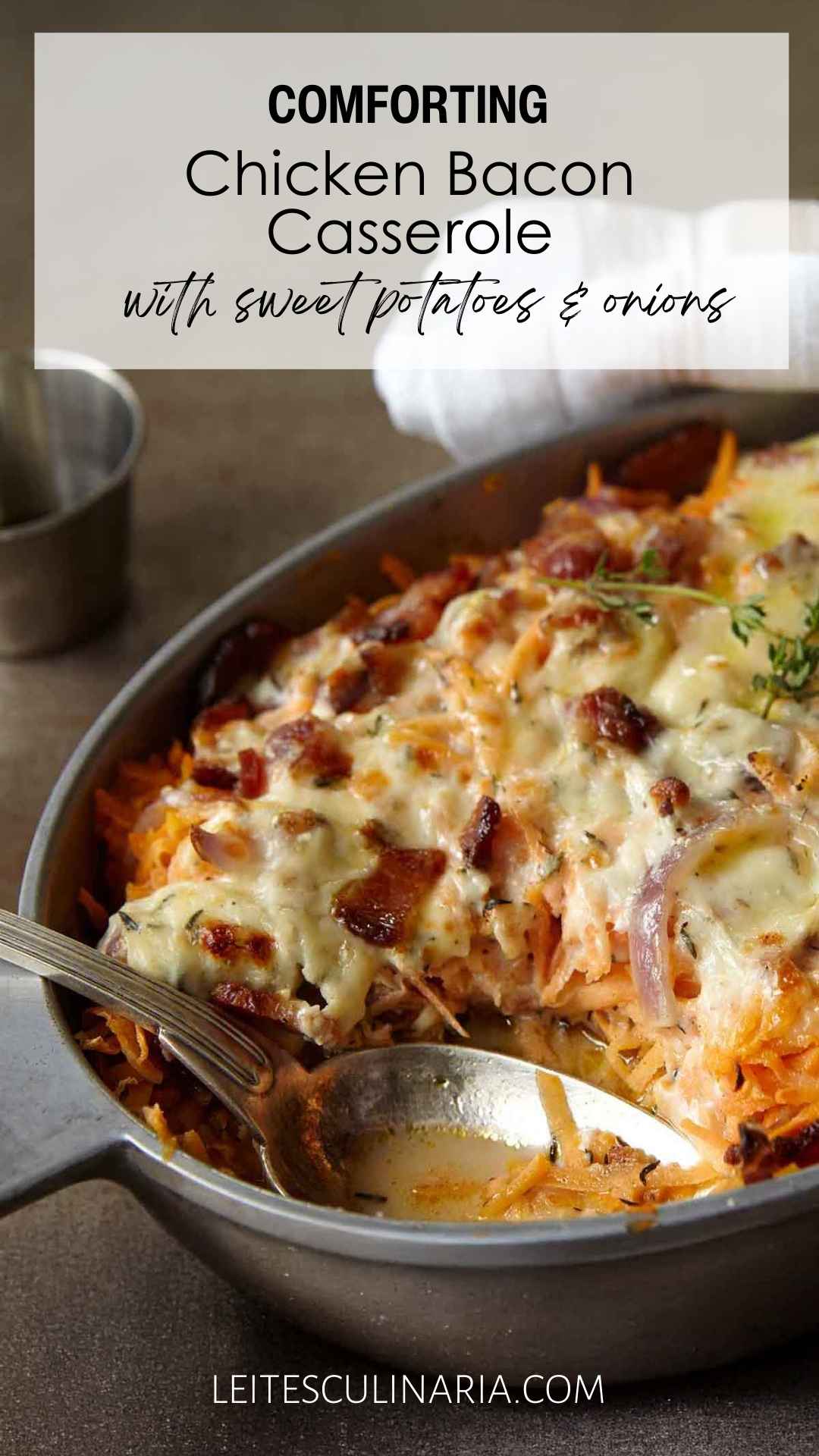 A chicken, sweet potato, and bacon casserole in an oval dish, topped with melted cheese.