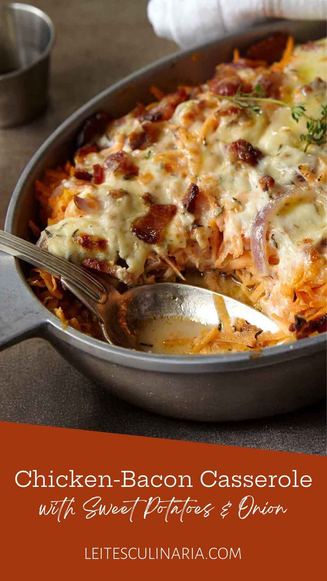 A chicken, sweet potato, and bacon casserole in an oval dish, topped with melted cheese.