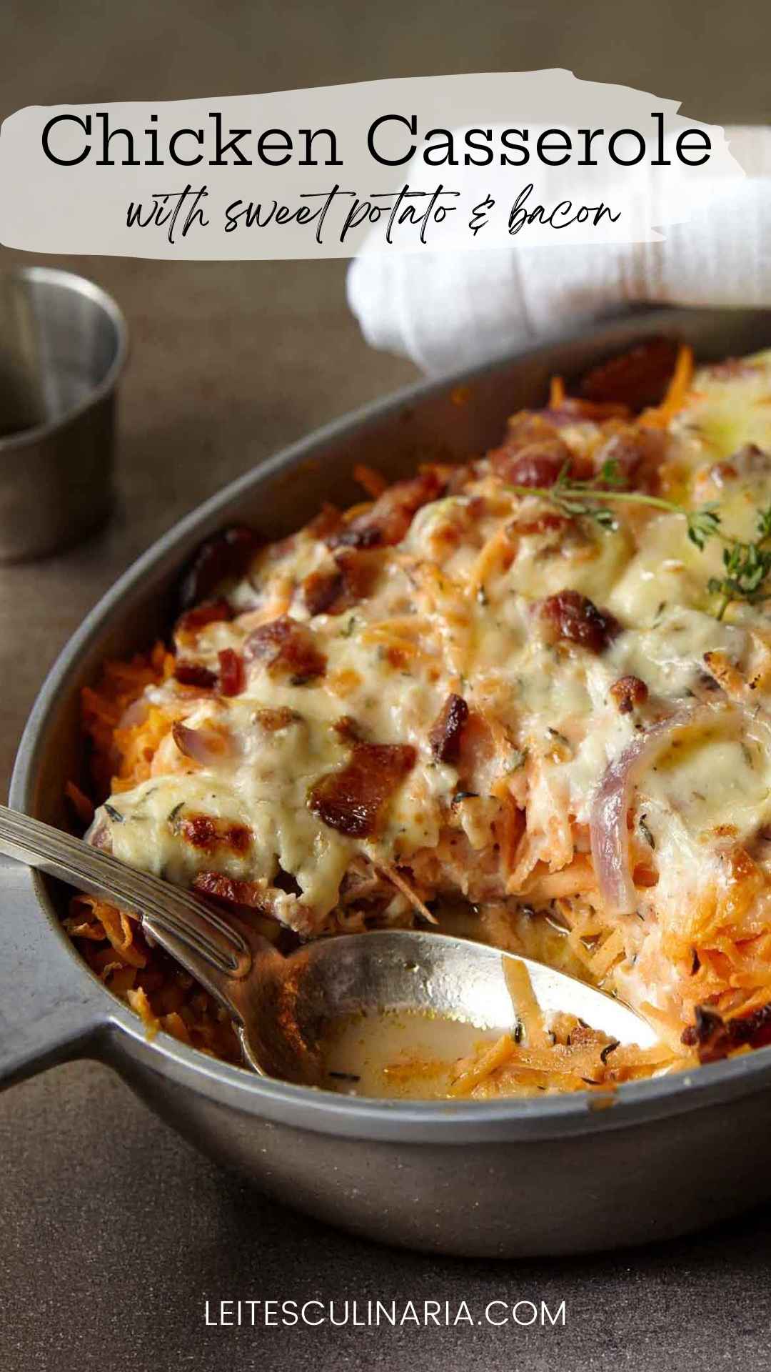 A chicken, sweet potato, and bacon casserole in an oval dish, topped with melted cheese.